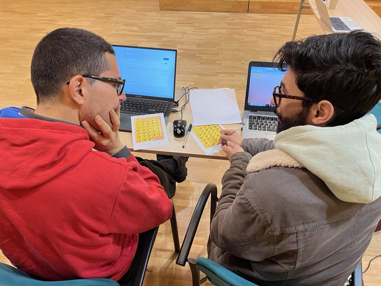 Two contributors discussing on the Awal datathon about different scripts of Tamazight